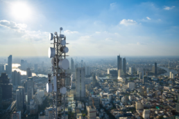 A Telecom tower against a cityscape background